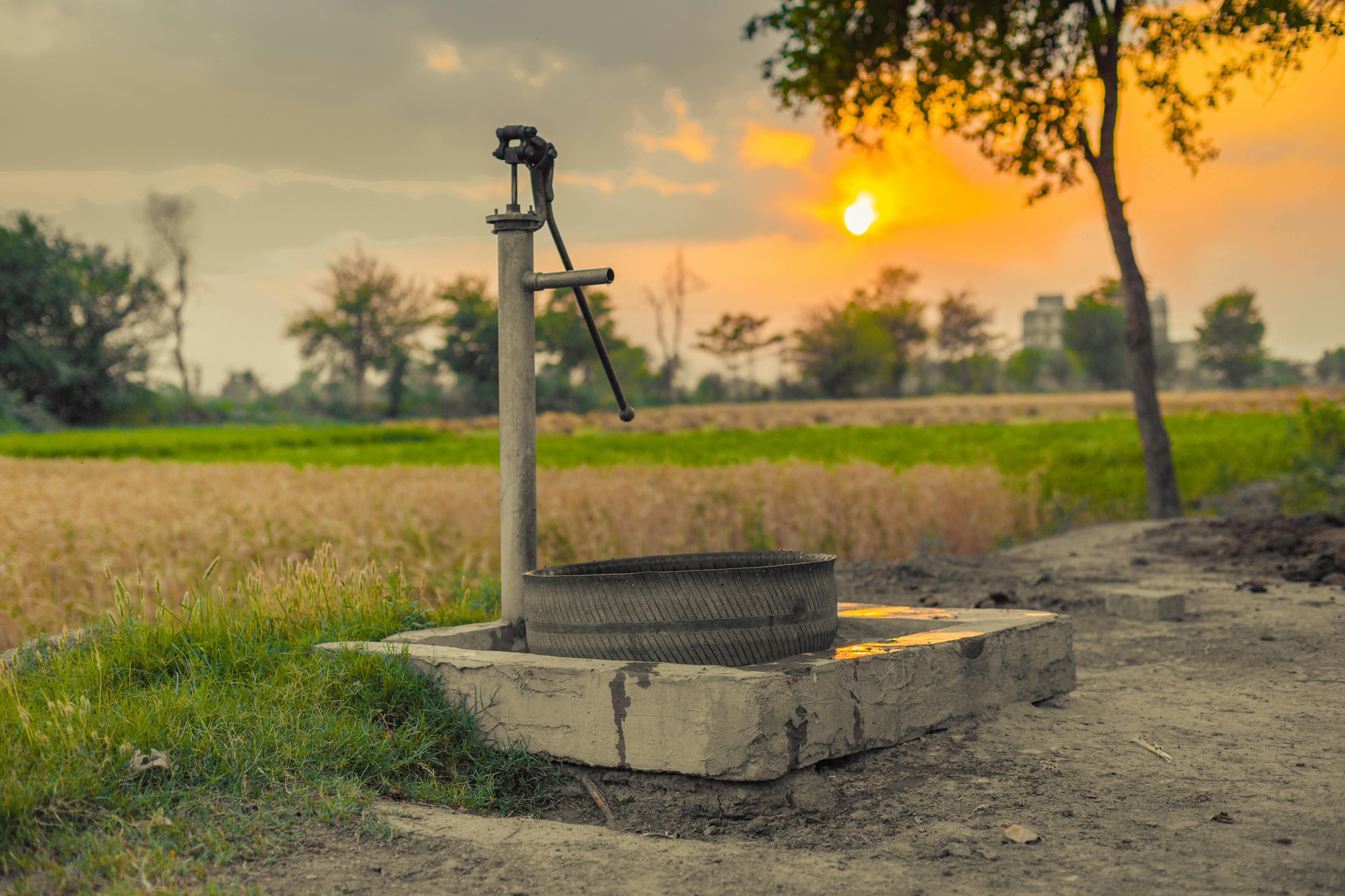 Rural water pump at sunset
